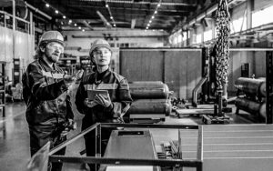 Explaining Coworker How To Use Industrial Crane
