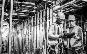 Workers Using Tablet Computer On Site