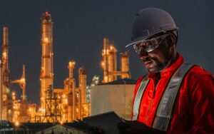 Engineer Using Tablet Near Oil Refinery Industry.