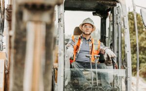 Construction Worker Operating Earth Mover