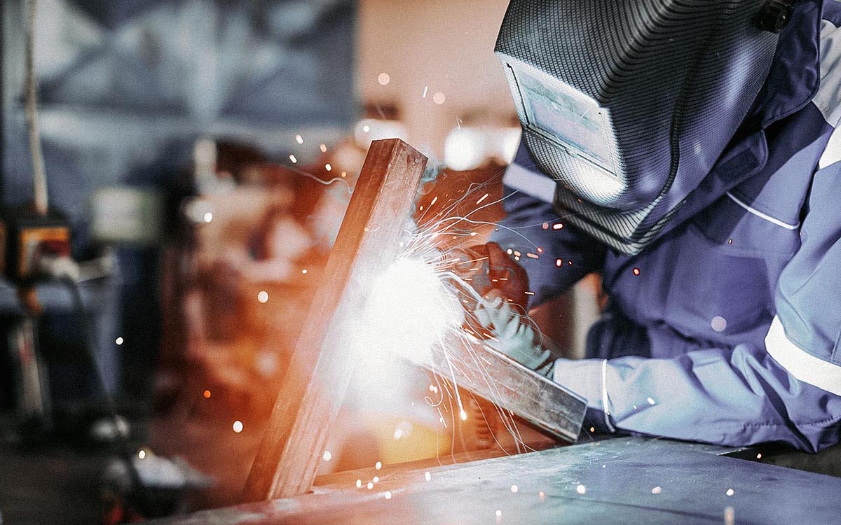 Professional Welder In A Factory Welding Steel Bars