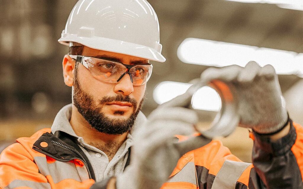 Quality Assurance Plan To Improve Production Quality. Male Quality Control Engineer Taking Random Samples To Inspect Auto Parts On The Production Line To Conduct And Followed Production Standards, Material Integrity, Shapes, Models, And Faults.