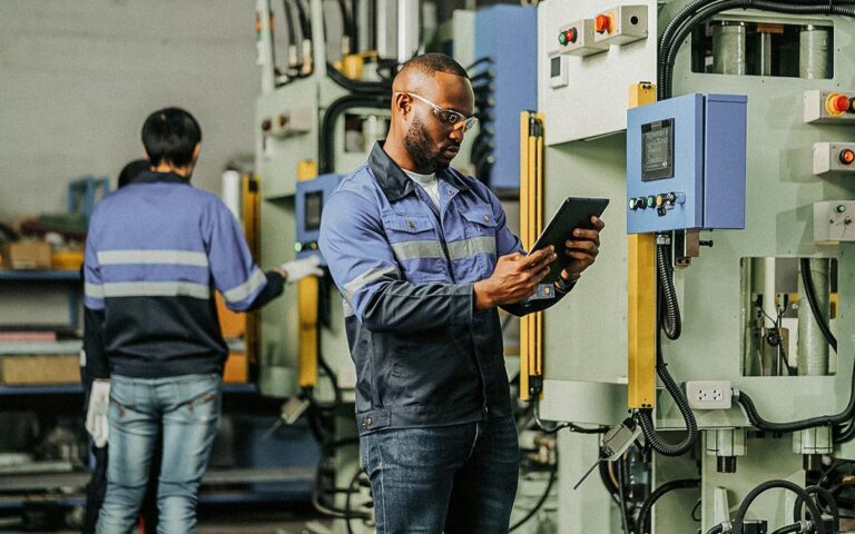 African American Engineer Hand Hold Laptop Process Operation Checking Manufacturing System,smart Technician Input Nc Data Program To Control Of A Cnc Machine In Automotive Industry. Operation In Automotive Technogy Factory
