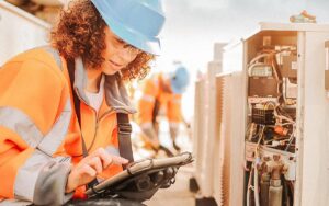 Female Electrician With Aircon Unit