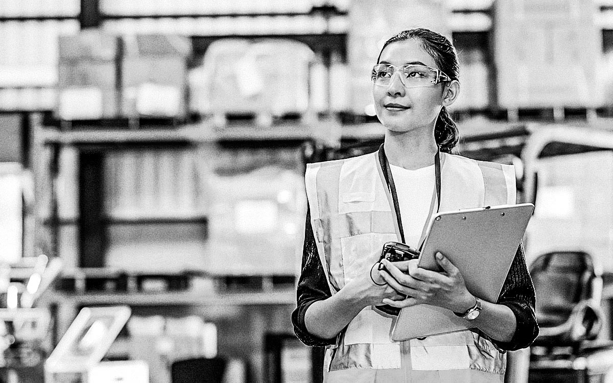 Portrait Of Female Warehouse Supervisor Working In Leading Distribution Warehouse. She Having Skilled In Audit Daily Operations, While Controlling And Managing Inventory And Logistics.
